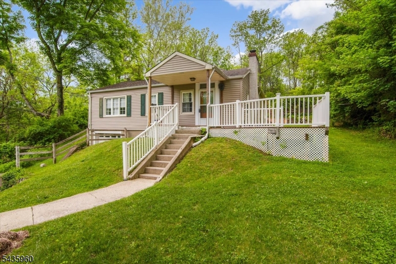 WELCOME HOME! This inviting 3-bedroom, 1.5-bath ranch set on a private, wooded lot in desirable Blairstown. This home offers a beautiful, flowing layout designed for both comfort and entertaining and features beautiful hardwood floors throughout the entire home. The main living area showcases a wood-burning fireplace and is flooded with natural sunlight, creating a warm and welcoming atmosphere. The updated kitchen with sleek granite counters is perfect for the fussiest of chefs. A huge family room with cathedral ceilings and sky lights adds dramatic space and light, making it ideal for gatherings or everyday living. Step outside to your own entertainer's delight a beautiful patio overlooking a fenced-in, built-in pool, all surrounded by tranquil woods for exceptional privacy. Whether hosting summer get-togethers or enjoying peaceful evenings, this backyard truly shines.  Updates included new septic 2023, new deck, french drain, newer pool liner. Designed for easy one-level living, this home blends charm, space, and indoor-outdoor enjoyment in a serene setting. A rare opportunity to own a light-filled, private retreat with outstanding entertaining spaces don't miss it.