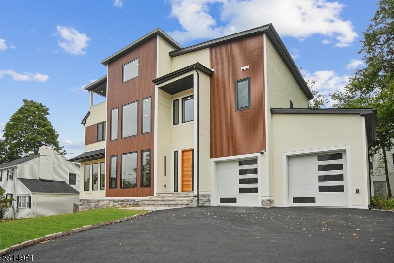 Welcome to this breathtaking, newly constructed contemporary home, boasting modern finishes and luxurious touches throughout. As you enter the first floor, you'll be greeted by a spacious living room with soaring 19-foot ceilings, leading to an inviting family room and a beautifully designed kitchen and dining area. The kitchen is a chef's dream, featuring high-end Thermador appliances, including a 36-inch gas cooktop, 36-inch pro-grade range hood with 600 CFM, and a 30-inch combination wall oven and microwave set. The centerpiece of the kitchen is the impressive 10-foot waterfall center island with quartz countertops on both sides, complemented by sleek quartz counters and a stunning quartz backsplash. The first floor also offers a spacious bedroom and a full bathroom for convenience. The second floor features two generously sized bedrooms and a modern full bathroom, master bedroom, providing privacy and comfort. The third floor adds two more bedrooms, a full bathroom, and a charming balcony, perfect for enjoying your morning coffee or evening sunset. For entertainment and relaxation, the finished basement is fully equipped with a theater room, a recreational room, a storage room, and a utility room, along with another full bathroom. The home also includes a two-car garage and ample storage space, completing the perfect combination of luxury, functionality, and style. The lawn area features a sprinkler system for easy maintenance.  Don't miss out on this rare opportunity!