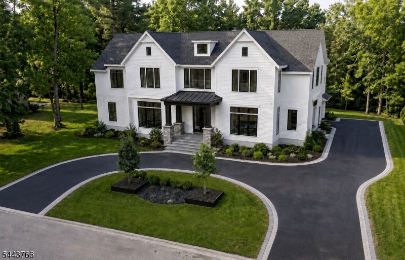 New Construction custom luxury residence in the prestigious Deerfield section of Short Hills, offering approximately 10,000 finished square feet across three levels on a rare three-quarter-acre property. Designed for elevated living, entertaining, and wellness, this 7-bedroom, 7.1-bath home showcases grand scale, refined craftsmanship, and curated finishes, including a double-height foyer, custom hardwood floors, oversized tile, elevated ceilings, architectural detail, and statement lighting.The chef's kitchen features custom cabinetry, quartz countertops, Sub-Zero and Wolf appliances, two dishwashers, oversized island, pantry, and seamless flow to the family room and main-level bar. The primary suite offers vaulted ceilings, private balconies, boutique-style dressing closet, walk-in closet, and spa-caliber bath with radiant heated floors, soaking tub, custom vanities, and glass-enclosed shower.Flexible spaces include en-suite bedrooms, guest accommodations, two home offices, and two laundry rooms. The walkout lower level with 10-foot ceilings offers a media room, golf simulator, fitness studio, wine cellar, guest suite, bonus spaces, and full Manhattan-style sports bar. Highlights include speakers, EV charging, smart-home technology, security system, generator readiness, two bar areas, and heated three-car garage. Grounds offer patio entertaining, custom pool potential, and serene Zen garden setting near Millburn schools, parks, shopping, dining, and recreation.