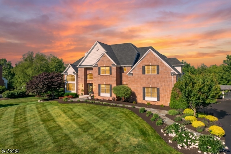 Showcasing over 5,300 square feet of well appointed living space, this remarkable Montgomery Township home features a full walkout basement and beautifully designed spaces for both everyday living and entertaining. A dramatic two story foyer welcomes you into elegant formal living and dining rooms, while the sun filled family room features a wood burning fireplace and walls of windows overlooking the picturesque backyard. The gourmet kitchen showcases 42 inch cherry cabinetry, stainless steel appliances, and a large center island with breakfast bar seating. Hardwood flooring extends throughout much of the home. The luxurious primary suite includes a spacious sitting room, walk in closet, dressing area, and a beautifully renovated bath with dual vanities, oversized shower, and Jacuzzi tub. Generously sized secondary bedrooms offer walk in closets and abundant space. The finished walkout basement adds incredible flexibility with a private office, den, large recreation area, and a second kitchen with quartz countertops and appliances. Outdoor living is unmatched with a maintenance free TimberTech deck, expansive patio, and custom built rustic industrial bar complete with ceramic countertops, 5 Tap kegerator, sink and bar seating. Additional highlights include a newer roof (2023), two zone HVAC systems replaced in 2022, and brand new garage doors. A rare opportunity to own a beautifully updated home in one of Montgomery Township's most sought after locations.