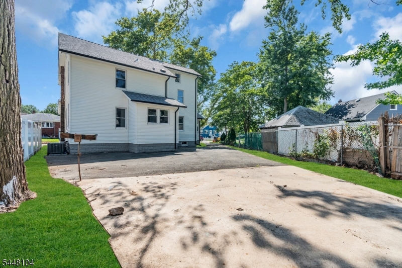Completely renovated from top to bottom, this exceptional 5-bedroom, 2.5-bath home offers the perfect blend of quality craftsmanship, thoughtful design, and modern living. From the moment you arrive, you'll appreciate the curb appeal, private driveway, new roof, and dual-zone HVAC system.Step inside to a welcoming foyer with rich hardwood floors and a beautifully restored staircase. The sun-filled living room features oversized windows and a striking marble fireplace, flowing seamlessly into the formal dining room.The designer kitchen showcases warm wood cabinetry, quartz countertops, a waterfall island with seating, a premium stainless steel appliance package, designer lighting, and abundant cabinet and prep space. Just beyond, the spacious family room, private home office, and stylish first-floor half bath complete the main level.The second floor features a spacious primary suite with a beautifully designed ensuite bath, two additional bedrooms, and a beautifully renovated bathroom. The finished third floor offers two more bedrooms, perfect for guests, a home office, playroom, or fitness space.The partially finished basement features sleek epoxy floors, washer and dryer hookups, updated mechanical systems, abundant storage, and versatile space that can easily adapt to your lifestyle.Additional upgrades include updated plumbing and electrical, hardwood floors throughout, and designer finishes at every turn. Simply unpack and enjoy.