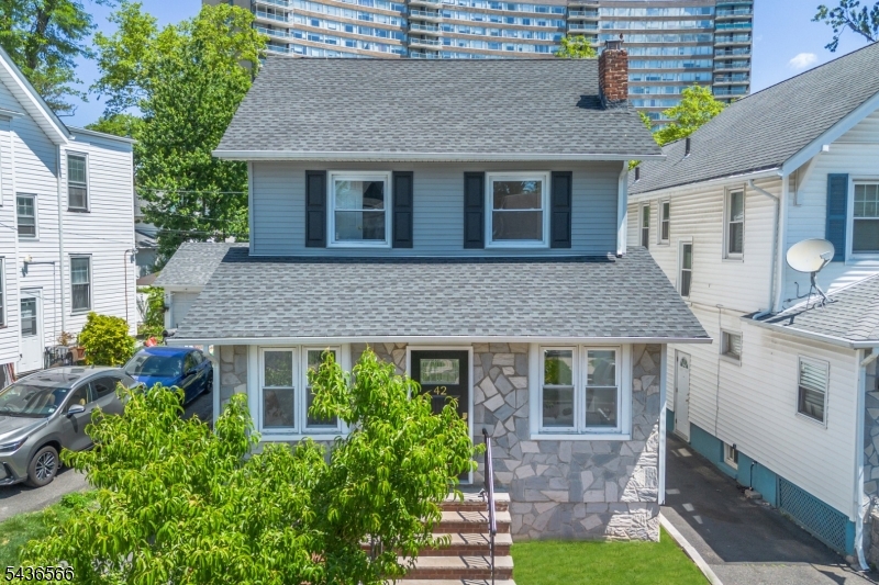 Welcome to 42 Wayne Avenue, a beautifully updated Colonial offering three bedrooms, one full bath, one half bath, and flexible living space across three finished levels. Situated on a picturesque tree-lined street, this move-in ready home combines modern updates with everyday convenience. The heart of the home is the stunning renovated kitchen featuring quartz countertops, stainless steel appliances, center island seating, and an open flow to the dining and living areas, creating an ideal space for everyday living and entertaining. Upstairs you will find three bedrooms and a beautifully renovated full bath. A finished walk-up attic provides valuable bonus space ideal for a home office, guest area, fitness room, media room, or creative retreat. The finished basement expands the home's functionality with additional living space, laundry area, and convenient half bath. Outside, enjoy a spacious backyard, deck for outdoor entertaining, and a private driveway accommodating two vehicles. Commuters will appreciate easy access to the Brick Ch_rch NJ Transit Station with direct service to New York Penn Station, as well as nearby Route 280, the Garden State Parkway, shopping, restaurants, and Monte Irvin Orange Park. Eligible buyers may qualify for CRA mortgage programs offering below-market interest rates, as little as 5% down, and no buyer-paid mortgage insurance. A rare opportunity to own a thoughtfully updated home in one of East Orange's most convenient locations.
