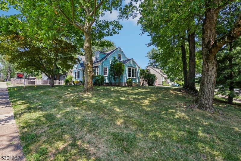 Don't miss this charming recently refreshed cape set directly across the street from the Madison recreational complex of ball fields, a dog park & the community pool!  It is set in the Knollwood section of Madison close restaurants, shopping and NYC direct train. Lovely level lot with great curb appeal. Plenty of space to play around the fully fenced in area of the side and back yards, yet still have the sweet patio off the kitchen to enjoy the garden while lounging or entertaining. Lots of natural light all the way around the house. 2 bedrooms on the main floor make it easy for someone who is stair challenged. Kitchen & dining room floors are vinyl tile for easy clean up; Natural oak hardwood cover the rest of the main floor. 2nd floor is an open full front to back carpeted cozy space for bedroom and/or office/study. Convenient built-ins into eaves for storage. Highly possible to dormer off the back of the house to add a bathroom upstairs.  Partially finished basement has great media area set up for movies or gaming with room behind theater seating for whatever works for you!  Use it as an exercise area or a work space, or perhaps a beverage center?  Plenty of storage, workbench space and laundry in unfinished part of basement. Attached is a single car garage with nothing above.. It could be a base for a reno/addition expansion.  (It is the buyers responsibility to town verify for impermeable coverages and setbacks).  Included is also a large shed for extra outdoor storage.