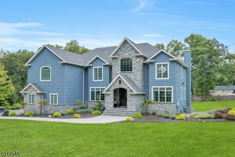 Welcome home to this one of a kind custom built home located in one of the most desirable sections of Parsippany. Perfectly situated on a pristine landscaped 1.7 acre lot with a separate detached guest house and a 45x30 paver patio for year round gatherings. The outstanding construction features incl: closed cell foam insulation along with a High Efficiency HVAC system which drastically reduces utility bills, the entire house in covered with real natural stone & Certainteed Vinyl Cedar Impression Siding as well as shaker corners, all interior walls have been insulated with sound proofing, 16 camera security system, lrg outdoor kit & bar, Anderson 400 series casement windows throughout, oversized base, casement & crown molding, 3 electrical panels, in wall HDMI & Cat 6 ethernet wifi extenders, 10 ft high bsmnt ceiling, all copper plumbing, high end kitchen cabinets with double waterfall edge, SS appliances, 2 tier center island, dark walnut oak stairs with wrought iron spindles in foyer & bsmnt, central vacuum, ceiling speakers thru out, 7 lights @ 24k lumens stadium spotlights, 130+ recessed lights, decorative shiplap ceilings (interior & exterior), and a sort after property that is not often available!! Approx 4800 sq ft of living space and an add'l 1800 sq ft in the bsmnt. Finished Basement with Full Bathroom & Bar, Minutes to major highways, schools, shopping & public transportation. Truly a dream come true! This impressive home is awaiting the most discerning of buyers!!