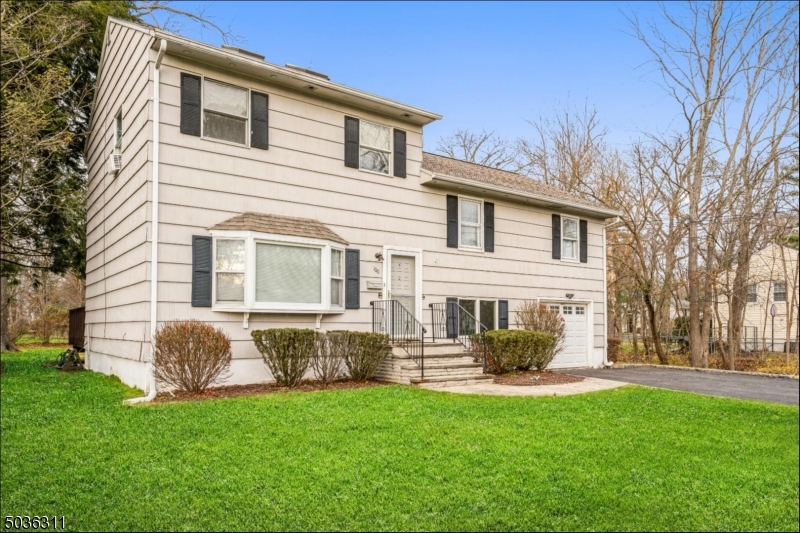 Sun-filled Split-Level on a perfectly manicured lot is located on picturesque tree-lined street. Beautifully updated w/ hardwood floors throughout. This well-maintained home feat lots of natural light & plenty of space for entertaining. On the 1st level, the LR flows seamlessly to the DR w/ sliders to the deck overlooking the private back yard, & an open concept kitchen w/ plenty of cabinet & counter space to make meal prep a breeze.  The 2nd level encompasses 3 bedrooms & a full bath, & the primary bedroom suite on the 3rd level includes a vaulted ceiling w/ skylight, huge walk-in closet & sumptuous private bathroom w/ a jetted tub & separate shower. The lower level offers a spacious rec room that could be used as den, office or playroom, plus a laundry room & convenient access to the attached one-car garage.