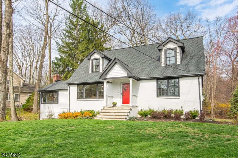 Nestled on a picturesque, level 0.60-acre lot in the heart of town, this custom Cape Cod home has charm, character & thoughtful updates. Tucked away w/ a driveway off Laurel Hill Rd, this gem offers serenity while being just steps from all that Mountain Lakes has to offer. Step into the stunning FR, where a soaring ceiling, oversized windows & a striking brick fireplace create a warm & inviting space filled w/ natural light. The newly renovated EIK is a chef's dream, featuring quartzite countertops, high-end SS appliances, custom cabinetry & a breakfast bar that flows into the formal DR, that  overlooks the rolling yard & opens to the FR. Outside, the deck invites you to dine and enjoy the peaceful surroundings w/ a stream & bucolic views. The 1st level also has 2 bright & airy bdrms and a crisp hall bath. The 2nd fl has 2 more bdrms & hall bath providing ample space for guests. The LL offers flexible living options w/ a finished rec room, gym, or home office w/ a private entrance, plus a laundry rm & plenty of storage. A brand-new high-efficiency heating system, along with recently updated composite siding, windows, and roof, ensures worry-free living. The detached 2-car garage & ample parking add to the home's convenience. Set in an unbeatable location across from Island Beach, where lake activities await, and with easy access to the Blvd Path, this home offers the best of ML living. Move right in & start enjoying this enchanting property and all the community has to offer.