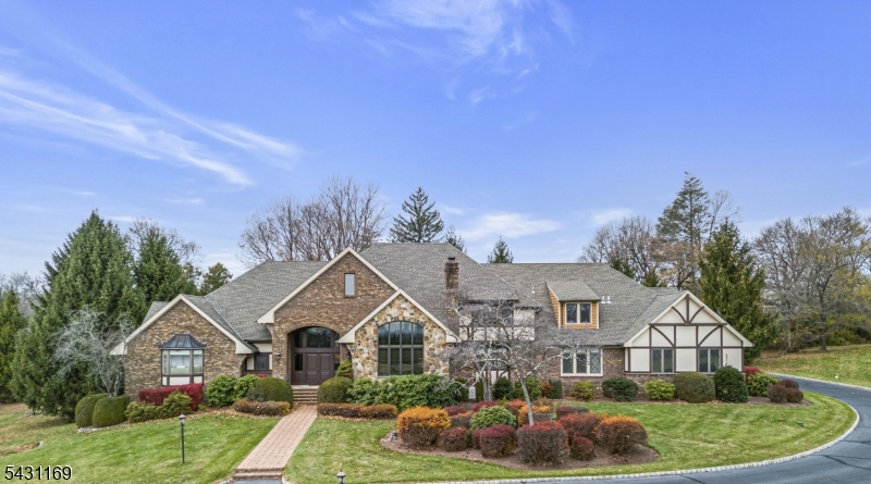 Nestled amidst 7 acres within an exclusive, private enclave, this exceptional estate inspires legacy-level living on Bernardsville Mountain. Sweeping sunrise & sunset views create an unparalleled setting for this custom, premium build. A dramatic 2-story foyer showcases custom hardwoods, sweeping staircase, powder room & adjacent soaring office w/spiral staircase to a handsome, lofted library. The formal LR was designed for grand scale entertaining, opening to a DR with sliders to an oversized veranda w/breathtaking views. Luxurious kitchen renovations (2022) incl. coffered ceiling, quartzite counters/island, Sub-Zero refrigerator, 6-burner Wolf range & dual wall ovens. From the kitchen, enjoy an inviting family room with coffered ceiling and transom windows, and an expansive wing w/amenities for everyday living in addition to a guest BR and full bathroom. On this level, the owners wing boasts an east-facing bedroom with vaulted ceiling, sitting area & dual primary baths w/ spa-like amenities & walk-in closets. Upstairs, a gallery hall leads to 3 lg. bedrooms with newer ensuite baths & walk-in closets, and a bonus room with flexible possibilities. An expansive walkout lower level is complete with full bath, kitchenette & abundant storage. The winding drive boasts elegant post lighting, ample parking & a heated 4-car garage w/lift " all within a picturesque landscape for estate living at its finest, just minutes from Mendham & Bernardsville downtown.