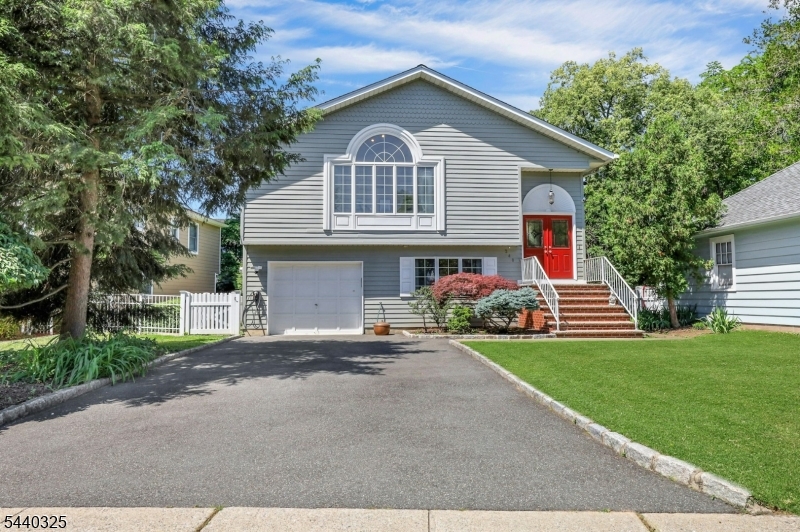 Fantastic Glen Rock neighborhood conveniently nestled between Ridgewood & Glen Rock downtown districts! Spacious home with wood floors throughout. Natural light floods the main floor which opens to a HUGE Living/Dining room with vaulted ceilings with skylights. Eat-in kitchen is large enough to host a breakfast table & also has vaulted ceilings with a skylight. Two bedrooms on main level including large primary with Lux Master bath room, Lower level has another enormous Family room with a wood-burning fireplace & sliders to the stunning backyard. Third bedroom & full bath are also on this level. The backyard of this home is truly a stunning sanctuary. Flowering gardens and privacy bushes perfectly line the stone patio, complete with a waterfall fountain adding the peaceful sounds of nature. Quaint white-picket fence throughout adds charm and style making this delightful backyard space ideal for entertaining & relaxing. Don't miss this fantastic home in top-rated school district and convenient to everything!