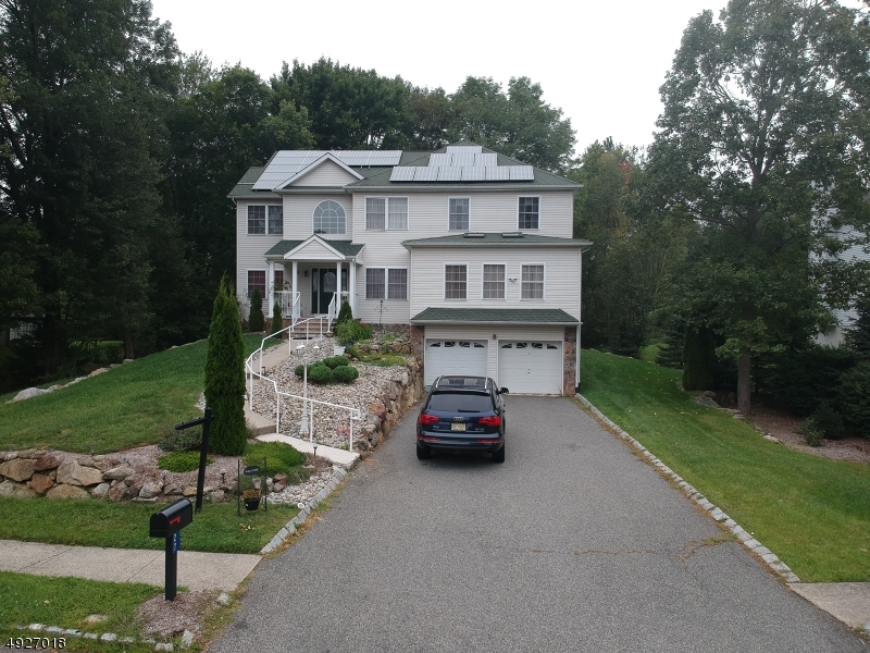 Welcome Home to Water Village. This gorgeous 5 BR Colonial offers a master BR on the main level, 4 BR upstairs including another huge master BR with jetted tub, double vanity and walk in closet. Other 3 BR very spacious. Main level features DR, LR, FR with FP, kitchen with center island, MB and an extra big room for an office/den/library. Laundry room on second level. Walk out basement leads to large back yard which walks directly to the lake. Skylights throughout the house give extra light for that open feeling. Environmentally conscious home offering owned solar system drastically reducing your electric cost. Plus you make revenue from the solar panels...you get paid!! Enjoy all the amenities Lake Hopatcong has to offer. Close to Route 15, shopping, major commuting routes.