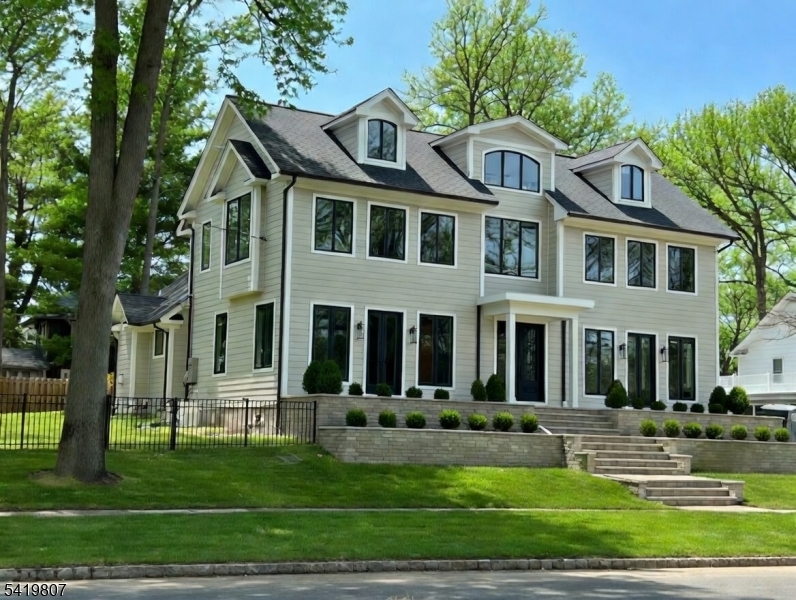 Stunning new construction on one of Westfield's most iconic streets! Built by Galaxy Building Contractors, this exceptional home blends luxury, craftsmanship & modern design. Featuring 8-inch-wide plank white oak floors & sun-drenched interiors throughout, every detail is thoughtfully curated. A grand foyer welcomes you into a beautifully designed layout, showcasing 1 of 2 primary suites on the first floor ideal for guests or flexible living. Elegant living & dining rooms w/ exquisite moldings flow into a dramatic family room w/ soaring ceilings & exposed beams. The gourmet kitchen features high-end appliances, gorgeous cabinetry, two dishwashers, two sinks, walk-in pantry, wet bar & bright breakfast area with built in butlers pantry, opening to a large patio & green space perfect for indoor-outdoor entertaining. First floor also includes mudroom & powder room. Upstairs offers a luxurious primary suite w/ spa-like bath & walk-in closets, plus 3 additional bedrooms including an additional en-suite. Third level adds bonus room, bedroom & full bath. Walk out finished basement w/ high ceilings, potential 7th bedroom w/egress window, full bath, and three additional large spaces/rooms great for theatre, gym and/or recreation area. 2-car garage & whole house generator. A rare opportunity offering space, style, and flexibility in a premier Westfield location. Walk a few blocks to train, bus, town and all schools! Completion expected for June 2026!