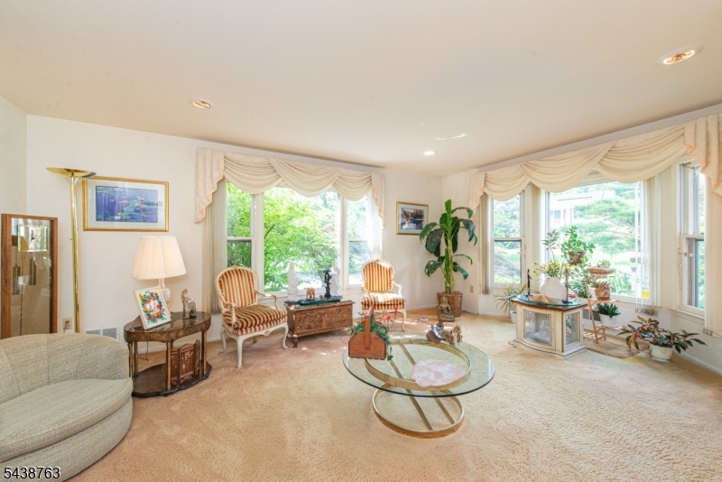 Welcome to this stunning Colonial located in a highly desirable neighborhood & set on a beautifully professionally landscaped lot, this home boasts a tranquil oasis in the backyard, featuring a serene pond, soothing waterfalls & a two-tiered deck perfect for entertaining or relaxation. A bright glass SunRm completes the outdoor paradise. As you enter the 1st floor, you're greeted by a center foyer w/beautiful marble floor & spacious formal living & dining rms,perfect for both casual & formal gatherings.The FamRm is accented w/a fireplace & offers easy access through a slider to the deck,creating a seamless flow between the interior & exterior.The large eat-in kitchen is a chef's dream w/center island,great counter space & a handy pantry.A convenient 5th BedRm/office completes the 1st floor,offering flexibility for your lifestyle.On the 2nd floor,a primary suite provides a private retreat,featuring a full bath w/jacuzzi,spacious walk-in closet & balcony overlooking the rear yard a perfect spot to unwind.3 other generously sized BedRms & full bath w/jacuzzi offer ample space for everyone!The entire home is light & bright,thanks to skylights that flood the rooms w/natural light,creating an inviting atmosphere!A FinBSMNT adds more living space w/full bath,storage & Jacuzzi.This home is the perfect blend of style,comfort & functionality,offering everything you need for modern living in a beautiful, serene setting. Don't miss out on the opportunity to make this your dream home!