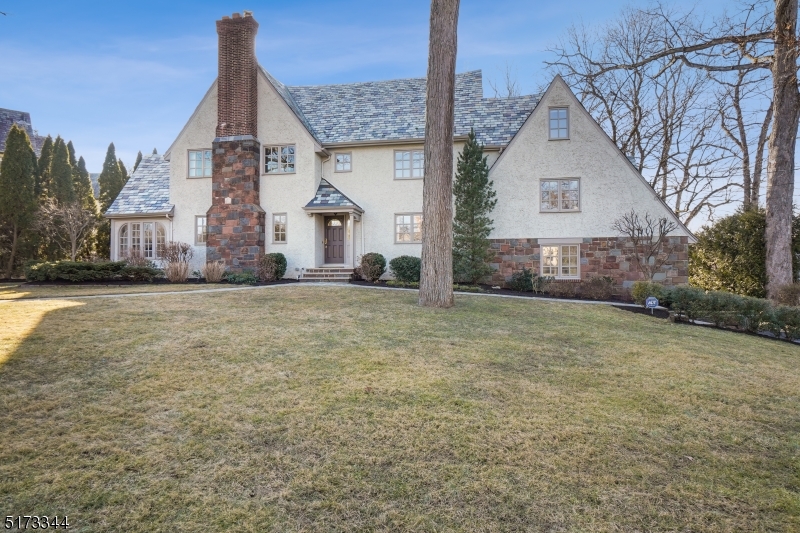 A light-filled American Tudor Revival thoughtfully renovated to highlight its original character. Features a new kitchen and four new baths, with stunning terraces and a picturesque yard on one of Summit's most desired streets.