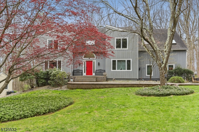 Welcome home to this 4 bedroom, 3.5 bath format colonial home with contemporary style located on a quiet cul-de-sac. You will be greeted by an airy double high foyer upon entry flanked by traditional formal dining and living rooms.  Enjoy the sunken family room with fireplace that overlooks a private deck and serene protected woodlands.  The large eat-in kitchen has newer stainless steel appliances: Bosch double wall ovens, electric Thermador cooktop, dishwasher, granite countertops, and wine fridge. The enormous primary suite boasts an oversized dressing room with jetted tub. The second floor is completed by 3 more bedrooms, shared bath and an open view of the family room below.  Skylights provide natural light throughout the home.  The two-car garage is large enough for two SUVs.  Hardwood floors on first level.  The full finished basement has a full bath and ample storage.  Minutes from downtown Morristown, the NJ Transit Train, major highways (287, 24, 80).
