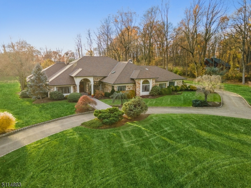 Stunning custom built home on a private cul-de-sac with 3.97 manicured acres in desirable New Vernon section of Harding.  Circular driveway with Belgian block curbing. Enjoy the spacious first level featuring an open floor plan with high ceilings, unique skylights, updated gourmet kitchen with high-end appliances, custom mill work and light filled dining area. Warm and bright family room features a wood burning fireplace, custom cabinetry and wet bar.  Elegant living room with gas fire place, formal dining room,  and warm library.  First floor primary bedroom , and 3 bedrooms each with en-suite baths complete the level.  Main level opens to large patio with built in grill,  in-ground heated pool with hot tub and picturesque lush landscaping and gazebo.  Upper level features a private bedroom with bath perfect for guests.   Finished lower level is an Entertainer's Dream with custom bar, catering kitchen, dance floor, expansive game room and gym.   Poured concrete and steel beam construction, newer HVAC and roof.  Less than 35 miles to Manhattan w easy access to nearby Morristown for entertainment,  train, shopping.