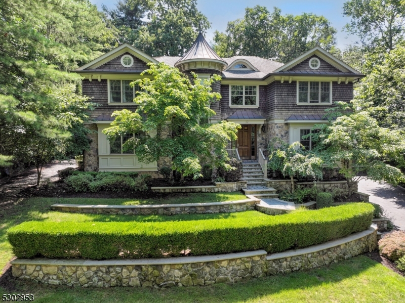 Successful tax appeal -New assessed value: $2,450,000. Luxury that endures - value that lasts! Sophisticated & grand 7 BR, 7.5 bath Center Hall colonial with spacious sun drenched rooms, every amenity, incredible privacy & serene views! Beautiful stone & cedar shake exterior, incredible spaces, amenities & conveniences, to impress & inspire the most discerning buyer! Dramatic living room & an elegant banquet sized dining room flank the spectacular 2 story foyer. The oversized gourmet kitchen has a large center island, high end appliances, new glass tile backsplash & overlooks the large family room with a fireplace & a wall of custom built-ins, large patio & lush, level, serene property. The office is Ideal for work-at-home needs. 1st level has 9' high ceilings, a wide rear hall, butler's pantry, spacious powder room, fine architectural details & a 2nd staircase to both, 2nd level & lower level. The dramatic 2nd level has an oversized hall, 5 oversized BR suites with large windows & closets & a laundry room. Impeccable condition, Pella windows, recessed lights, freshly painted interior & gleaming hardwood floors. Finished walkout lower level has another office, large gym, home theatre/entertainment area, bedroom, bath, mud room, plus an oversized 3 Car Garage. Minutes to highly ranked Deerfield Elementary School. Convenient location in a premier neighborhood. Close to Short Hills station, restaurants, Newark airport, highways, Short Hills mall