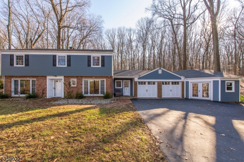 Beautiful country colonial home with 4 bedroom, 2.5 bath and 2 car garage plus workshop with separate entrance off garage. The foyer has slate tile and opens to the living room with hardwood floors, built-in bookshelves and also features a wood burning fireplace and access to a private patio. The first level includes a powder room, laundry room with a pocket door, and a renovated kitchen with granite countertops, solid wood cabinets, stone tile backsplash and tile floor. The breezeway mudroom has its own entrance, a pellet stove and allows access to the kitchen or garage plus an unfinished storage room that has potential for a great home office. The main bedroom has hardwood floors, a separate dressing area, ample closets and offers sliders to the newer deck overlooking the pool, and also includes a remodeled bathroom with a custom open shower with a waterfall shower head and custom stone floor.  The other 3 bedrooms are spacious and have hardwood floors. The main bath has a tiled jetted tub shower and a vanity with granite countertop. Other features include central air, newer windows, new roof and siding in 2020, in-ground heated pool, a private lot with shed. This home is perfect for those who love to entertain and enjoy the outdoors. Fantastic, serene, private lane with gorgeous country scenery!Showings by appointment only; active surveillance in use.