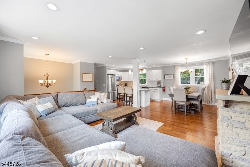 Completely renovated from top to bottom, this move-in ready bi-level combines modern style, flexible living space, and a quiet cul-de-sac location in desirable Lake Hiawatha. The open-concept main level flows seamlessly from the living room with fireplace to a large dining area and beautifully updated kitchen, creating a bright and inviting space for everyday living and entertaining. The kitchen features granite countertops, a center island with breakfast bar seating, custom cabinetry, a stylish tile backsplash, and stainless steel appliances. Gleaming refinished hardwood floors complete the main level.The home offers two fully renovated bathrooms, including a lower-level full bath with a walk-in shower. The finished lower-level recreation room is ideal as a family room, playroom, media room, home office, or flexible guest space and features direct walkout access to the backyard.Outside, enjoy a beautifully landscaped and private fully fenced yard with paver hardscaping, an above-ground pool, and plenty of space to relax, entertain, or play. Front-yard pavers add curb appeal, while the two-car garage provides convenient parking and storage.Additional upgrades include a new furnace, new water heater, central air conditioning, and central heat. Conveniently located near the neighborhood playground, public pool, schools, shopping, dining, and major commuter routes, this turnkey home offers comfort, style, and convenience throughout and is ready for its next owner.