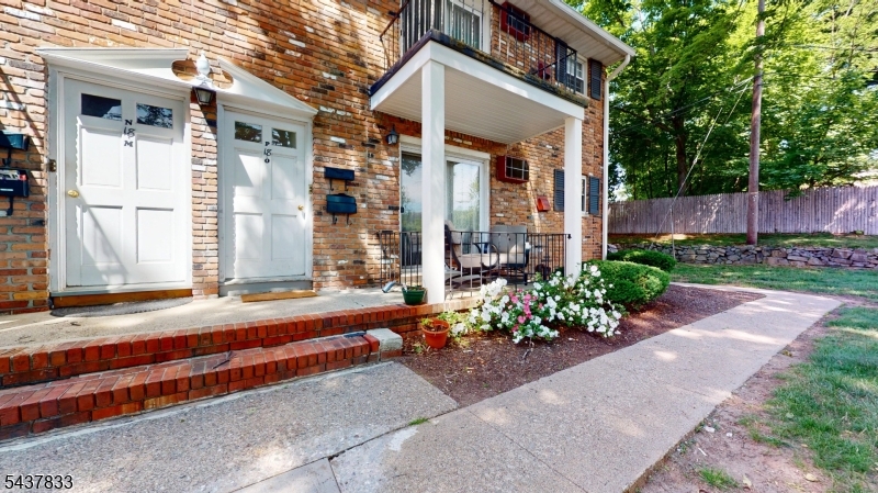 Located on South Street in Morristown, this single-floor apartment offers a well-organized layout comprising a combined kitchen and living room, one bedroom, one bathroom, and a hallway. The living and dining area is spacious and bright, featuring warm hardwood floors, recessed lighting, and baseboard heating. A sliding glass door with vertical blinds brings in natural light and offers outdoor views. The kitchen is thoughtfully designed with dark espresso cabinetry, white quartz countertops, a subway tile backsplash, and stainless steel appliances including a gas range, built-in microwave, dishwasher, and refrigerator. Open shelving and tile flooring complete the functional and modern aesthetic. The primary bedroom offers hardwood floors, recessed lighting, soft neutral walls, and two sets of double closets providing ample storage. The bathroom is elegantly appointed with large-format tile flooring, a white vanity with black hardware, and a glass-enclosed tub and shower combination with floor-to-ceiling tile surround and a natural light-providing window. Baseboard heating is present throughout the unit, as well as 2 wall A/C Units ensuring year-round comfort in this clean, updated Morristown apartment. Pool and picnic area with bbq for summer fun. Minutes to downtown train, restaurants and shopping. Maintenance fee includes taxes, heat, water, sewer, outdoor maintenance, snow removal, trash removal and pool membership. Terrific development maintained to perfection.