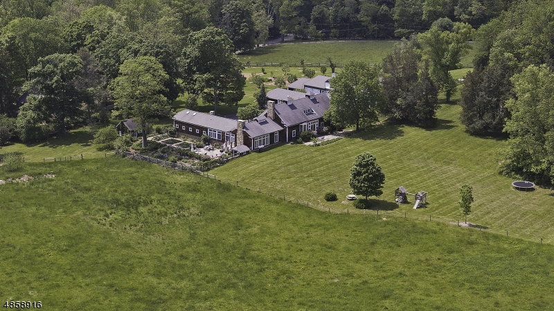 Unique converted barn in pastoral countryside setting- Pennbrook Farm constructed in early 1900's and renovated in 2004. The restoration process created a bright, airy, light filled home situated on 15 plus farm assessed acres.  2 bedroom cottage and two barns speak to the property's history as a working farm. Today a certified organic vegetable garden, apple and pear orchard carry on Pennbrook Farms agrarian legacy. Open floor plan includes 2 fireplaces, wood and mexican tile floors, soaring ceiling heights, beamed ceilings, classic crown moldings and numerous built-ins. Great cook's kitchen, 5 spacious bedrooms with walk in closets and built ins and all have own private bath or a shared full bath. 2 locations for Master bedroom. 2 car attached garage and a 4 car detached. Spectacular gardens- A must see!