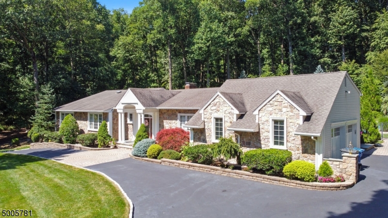 Gorgeous 1 fl living at its best! Spacious floor plan for casual & formal entertainment. This 4 bedroom, 3.1 baths, 1 office, has top of the line everything, Features a large kitchen w/separate, bright, dining area, center island, overlooking a large pavers patio, heated pool, landscaping, crown moldings, marble tile, granite & corian counter tops & 2 gas masonary FPs. The finished LL is complete w/ a custom-made mahogany bar, media room, billiards area, craft room, large private office, full bath, coffee bar, sitting area, huge storage room & walk out. The home's exterior has professionally landscaped grounds. Features a circular drive. Close to schools, town, highways & trains. Must see!