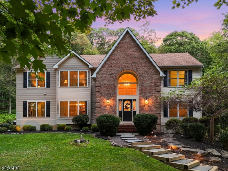 Experience the perfect blend of natural beauty and modern comfort at 30 Squire Hill Rd, nestled in the desirable Squire Hill neighborhood of Long Valley, NJ. This meticulously maintained home offers incredible privacy and stunning outdoor living spaces, including inground pool, deck, oversized patio w/fire pit, spacious yard enhanced by lush landscaping and outdoor lighting. Inside, a welcoming two-story foyer and 9-foot ceilings set the tone for the open layout featuring hardwood floors throughout foyer, dining room, kitchen, living room, family room. The updated kitchen is a chef's dream w/granite countertops, maple cabinetry, SS appliances, pantry. 1st floor also includes laundry room, powder room. Family room, highlighted by skylights and wood-burning FP, serves as heart of the home. Upstairs, generously sized BRs await, including spacious primary suite w/sitting area, walk-in closet, full bath. Additional features include newer thermal windows, newer water heater, two-zone heating/CA, generator hookup, partially finished basement w/rec room featuring pellet stove, mud room, ample storage. Located in Long Valley, known for excellent schools like West Morris Central HS w/IB Program, this home offers easy access to shopping, dining, major routes 46, 80, 78, and 24, as well as NJ Transit trains, buses for convenient commuting. Nearby parks such as Columbia Trail and Skinner Farm provide outdoor recreation opportunities, making this property a true retreat in Morris County.