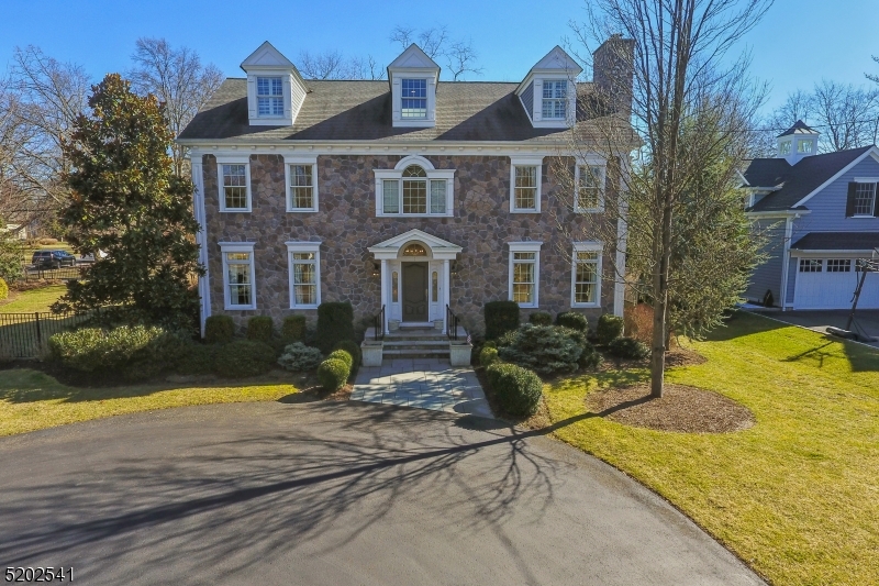 Elegance meets sophistication throughout this gorgeous center-hall colonial based in the heart of the Rolling Hill section of Chatham Township. You can't help but notice the craftsmanship of the custom staircases when you enter the home. Each detail shows pride of sole ownership throughout the four finished floors of over 7,000 square feet, thoughtfully laid out for living, working, and entertaining. Custom built in 2007 with updates and upgrades consistently, including a full new kitchen and bar with new appliances, light fixtures, marble and granite countertops, and new flooring in 2018. The entire exterior of the house was repainted in 2022. The light-filled kitchen is the heart of the home, opening to a family room. The first floor also has your formal living room, dining room, and office. The back staircase to the bunkhouse over the garage is just one example of the very smart layout of this exceptional home. Enjoy five spacious and light-filled bedrooms, plus two additional rooms that can be used as an office, den, or additional bedrooms, and five full and one-half bathrooms. The lower level is much more than a basement, complete with a full bar, gym, living and recreational rooms, full bathroom, and plenty of storage space. The two-car garage contains a wall storage system and sealed flooring, and bluestone front and side walkways. Recent upgrades include a fenced-in side yard and a seal-coated driveway. Come right home and enjoy the best of Chatham living.