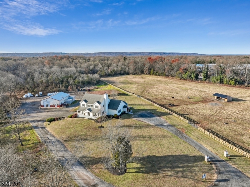 Welcome to this stunning 2006-built colonial set on an extraordinary 88-acre farm, offering a rare combination of natural beauty, functional land, and luxurious living.  Three expansive cleared fields - 10 acres, 11 acres, and 20 acres - provide ideal space for animals, hay, or future agricultural opportunities.  The home features a spacious, light-filled floor plan designed for both everyday comfort and elegant entertaining.  The gourmet kitchen shines with a center island, granite countertops, and stainless steel appliances.  Rich hardwood flooring, extensive trim work, and impressive coffered ceilings elevate the home's craftsmanship.  The inviting family room includes a warm fireplace.  A first-floor primary bedroom offers a peaceful retreat with a walk-in closet, jacuzzi tub, and standalone shower.  The home office provides flexibility and can easily serve as a fifth bedroom.  The 2nd floor hosts generously sized bedrooms, including a secondary primary suite.  The walkout lower level boasts high ceilings.  Adding tremendous value, the property includes a 2,500+ square foot outbuilding currently used as a fully equipped butcher shop with utilities, a bathroom, and an overhead door - creating an excellent opportunity for commercial income or conversion to other uses. With abundant acreage, versatile spaces, and a prime location close to highways, shops, and restaurants, this exceptional estate offers endless possibilities for living, working, and enjoying the outdoors.