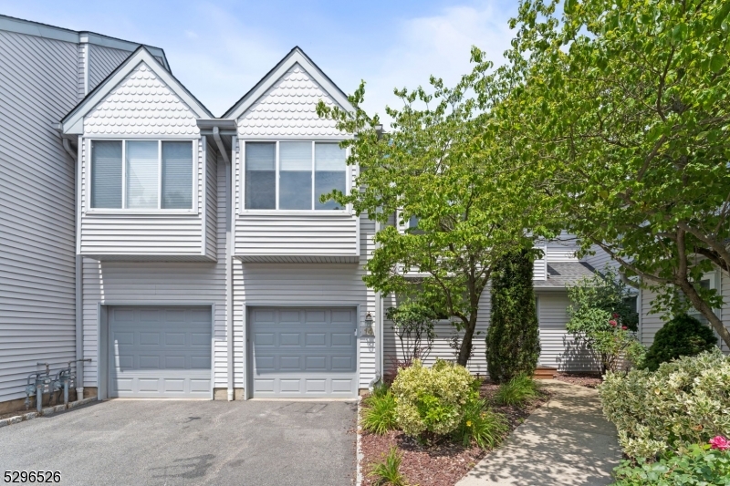 Welcome to The Meadows at Montville! This stunning corner-unit townhome offers 2 bedrooms, 2.2 baths and is situated in a desirable location in the community. As you enter, you'll be greeted by a spacious kitchen with stainless steel appliances, perfect for a breakfast nook or table. The kitchen flows seamlessly into the formal dining room, where sliding doors lead to a new deck (2023) that overlooks a private backyard, ideal for summer nights. The expansive living room boast high vaulted ceilings, a gas fireplace and skylights that flood the space with natural light. On the 2nd level, you'll find two generous-sized bedrooms, each with en suites. The primary bedroom includes a lovely sitting room, perfect for a home office, a spa-like en suite, a walk-in closet and large windows that let in ample natural light. This level also features the convenience of a W/D. Retreat to the fully finished basement, which offers a bright recreational space and two bonus rooms, perfect for an additional home office, playroom or exercise room. With 3 levels of completed space, this townhome has everything you need for comfortable living. Situated close to all that Montville has to offer and just a stone throw away from the Clubhouse, exercise room and pool, this home is a must see. Don't miss the chance to experience this beautiful home for yourself!