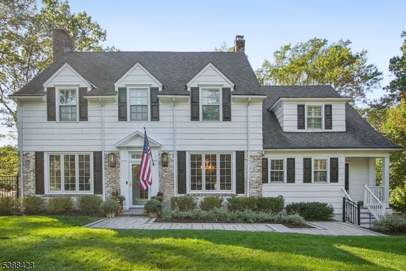 Nestled on one of Summit's most desirable Northside streets, this timeless Colonial residence masterfully blends classic elegance with modern luxury. Located within the top-rated Lincoln-Hubbard School District, the home offers a rare opportunity to enjoy refined suburban living in a truly exceptional setting. A gracious foyer welcomes you into beautifully appointed interiors that balance comfort and sophistication. The expansive Living Room and formal Dining Room are ideal for entertaining, while a sunlit Sitting Room provides a peaceful retreat. The heart of the home is the beautifully updated, bright Eat-In Kitchen outfitted with top-of-the-line appliances, 2 dishwashers, custom cabinetry, and premium finishes. Just off the kitchen, a spacious Family Room invites relaxed everyday living. The first floor also features a private Office. Upstairs, five generously sized bedrooms include three with en-suite baths. The large finished basement, complete with a sixth bedroom and full bath offers a spacious recreation area. The home offers laundry on both the 2nd floor and in the basement.  Step outside to the newly updated outdoor space featuing a heated pool, hot tub, and a state-of-the-art entertainment system and kitchen all surrounded by lush, professionally landscaped grounds. Blending traditional charm with modern amenities, this distinguished home offers an unparalleled lifestyle in one of Summit's most prestigious neighborhoods.