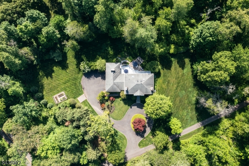 Welcome to 77 Pleasantville Road, a masterfully designed residence where modern luxury meets timeless Harding charm. From the moment you step inside, the home's scale is immediately apparent, boasting soaring 10-foot ceilings across every single level. This architectural choice, paired with an abundance of oversized windows, floods the home with natural light and creates an airy, expansive atmosphere that's hard to find. The heart of the home is a seamless open floor plan with the kitchen opening up to a large family room, perfect for both intimate evenings and large-scale entertaining. Every corner reveals thoughtful craftsmanship and high-end Details that elevate the living experience. With six spacious bedrooms and 4.1 sophisticated bathrooms, there is ample room for everyone to find their own retreat. (Please note: the town verifies a 5-bedroom septic capacity). The home has 2 ensuite bedrooms on the first floor allowing flexibility. The interior's elegance extends effortlessly outdoors. The private backyard is a lush sanctuary, featuring professional landscaping that provides a serene backdrop for morning coffee on the deck or summer dinner parties under the stars. Tucked away in one of the area's most coveted locations, this property offers a rare blend of sophisticated design and peaceful privacy. It's not just a house; it's a lifestyle waiting for you to move right in.