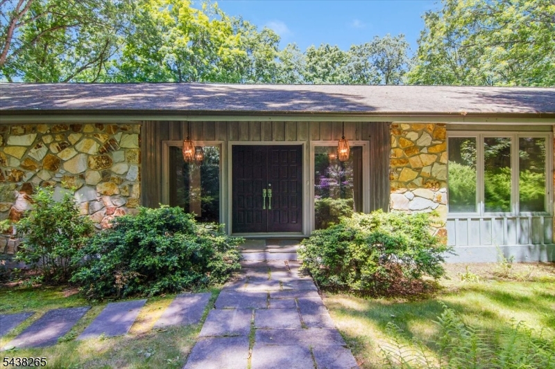 Welcome to a home that feels both grand and welcoming, where contemporary design meets peaceful country living. Sunlight pours through wide sliding doors, illuminating the open floor plan and rich wood floors that flow throughout. Enjoy effortless access to the pool, patio, and tranquil wooded backdrop, perfect for gatherings or quiet mornings. A private apartment offers comfort and independence for guests, staff or extra living while the fully finished basement with its own full bath expands your living and entertainment options. For the equestrian buyer or anyone with imagination the property includes a well-appointed barn with three stalls, tack room, electric, and water. It's ready for horses or ready to transform into the creative or functional space you've been dreaming of. Perhaps a private sanctuary, home school space, artist retreat, the sky is the limit.