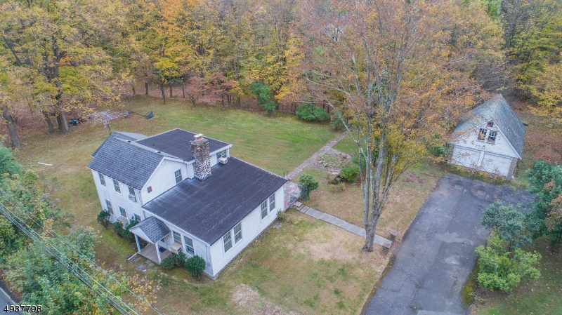Special Find! Custom Colonial w/Historic Feeling & LOTS of Dream Home Potential. Park Like Setting, Gorgeous Level 1 ACRE Property. Many great features including large living room w/oversized WB fireplace. HW Flooring throughout, under carpeting. Eat-in kitchen & formal dining room provides spacious entertaining options. Make it your own! Numerous features to fall in love with. 1st floor master bedroom + 2 large addtl bdrms on 2nd floor & bath. Vintage Details. Detached 2 car garage w/loft. Plus full, dry, unfinished bsmt for laundry & utilities. Natural gas, public sewer & water, Multi-Zone Heat. HURRY UP- once in a lifetime Denville property! Ideal location near mass transit, hwys, shopping & top schools. Close to DWTN Denville & hospitals.