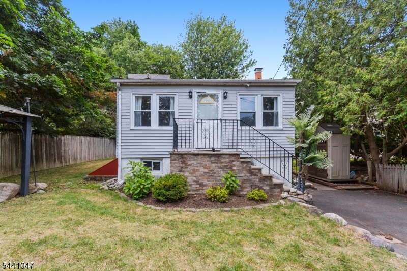 Tucked away on a private, tree-lined lot, this charming ranch offers the perfect blend of cozy character, flexible living space, and outdoor enjoyment.This 2-bedroom, 1-bath residence features an inviting open-concept layout with abundant natural light, hardwood-style flooring, and a spacious living and dining area centered around a classic brick fireplace. The functional kitchen offers ample cabinet and counter space and provides easy access to the backyard, making everyday living and entertaining a breeze.The finished lower level adds valuable flex space ideal for a family room, home office, gym, or recreation area, along with a dedicated laundry area and additional storage. Outside, enjoy a large deck overlooking the fenced backyard surrounded by mature trees, creating a private setting for relaxing, gardening, or hosting gatherings. A storage shed and off-street parking add to the home's practicality.Situated near local lakes, parks, hiking trails, shopping, dining, and major commuter routes. Conveniently located with easy access to Route 23 and nearby amenities while still enjoying the peaceful surroundings that make West Milford so desirable.