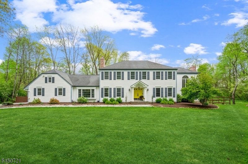 Timeless elegance in a serene setting! Stunning Colonial home on almost 2 acres of freshly landscaped prop. This home incl a massive deck w/a hot tub overlooking the beautifully designed backyard. This private oasis features a shaded stone paver patio, a gravel patio & walkways. There is also a storage shed & a 20x20 ft outbuilding w/a concrete flr & electric providing a great space for a workshop.The luxurious interior feat hardwood flr & crown molding, w/the foyer opening to a sun-filled LR. French doors lead to a gorgeous 2-story great rm w/floor-to-ceiling windows, fireplace, built-in bookshelves & an oak spiral staircase to the primary BD. The spacious, eat-in kitchen feat granite counters, high-end appl. A stunning sunroom off the kitchen makes a delightful breakfast rm w/vaulted ceiling, skylights & 3 walls of windows. Flow continue into the FR boasting a raised-hearth brick fireplace, skylights & views of the deck & property. A powder rm, laundry rm & access to the attached 2-car garage complete this level. 2nd flr includes the primary BD w/a spacious WIC, a back stairway& private BTH. 3 addtl BDs share a hallway bathroom. The fully finished lower level offers a huge recreation rm, wet bar, an office with built-in shelving, a half BTH & plenty of storage.This home is located near the Chester border & within easy reach of stores, restaurants & the highly regarded Long Valley school system. A cleared walkway on the property leads directly to the nearby Columbia Trail.