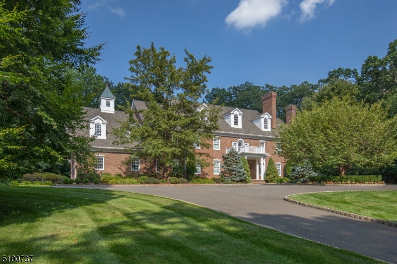 An impeccable all-brick Georgian Colonial with gated, private cul-de-sac setting has been meticulously maintained and decorated.Versatile 3rd floor expansion and 6 BR septic.Pool,finished lower level A stunning classic on the Bernardsville Mountain, located off a private road on fully fenced grounds includes a pool and waterfall spa plus bluestone patio across the rear of the home that links to the first floor rooms.Inside, a glorious white kitchen with dining area opens to the Family Room and beyond to a handsome bar room with full bath.A wood-paneled library and spacious office with multiple work stations are complemented by another den/office on the second floor.Second floor:Beautiful primary suite with double baths,sitting rm;3 BR suites; large FR/game rm or 5th BR. Add'l 2,000 sq ft finished lower level