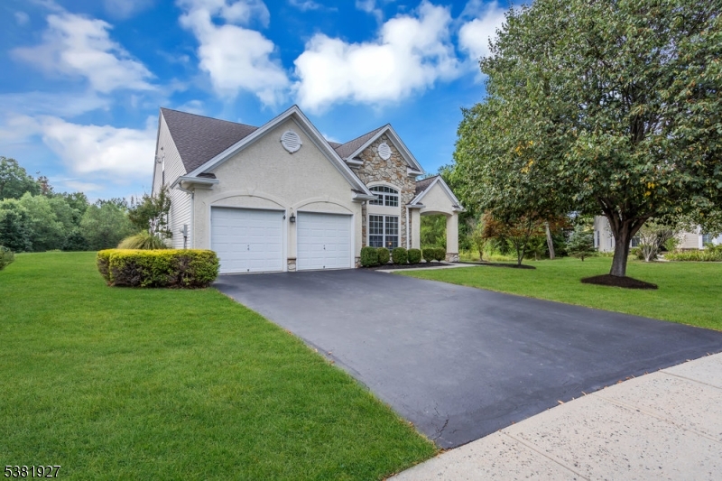 Welcome to this stunning Lincoln Manor model in Wellington Manor, a 55+ Community. This beautifully maintained stone & stucco home sits on a private, cul-de-sac lot and is loaded with upgrades. The gourmet eat-in kitchen features freshly painted 42" maple cabinets, granite countertops, stainless steel appliances, tile backsplash, and solar tube lighting. The two-story great room impresses with vaulted ceilings and a floor-to-ceiling stone fireplace, while the formal dining and living rooms add elegance with crown molding and a Palladian window. The first-floor primary suite offers a tray ceiling, sitting area, walk-in closet, and spa-like bath with soaking tub & separate shower. Upstairs includes a private guest bedroom with full bath, spacious loft (currently used as a bedroom), and large storage closet.  All new flooring on first floor.  New stair runners and wall-to-wall carpeting on second floor.   Brand new roof in 2025. New 220 amp electric in garage for EV charging. Enjoy the paver patio with motorized awning and private backyard views. Recent updates include a newer HVAC, hot water heater, updated baths, custom blinds, and upgraded recessed lighting. Community amenities: clubhouse, pool, fitness center, tennis & bocce courts. Conveniently located near Princeton, Pennington, Bucks County, and major routes to NYC & Philly.