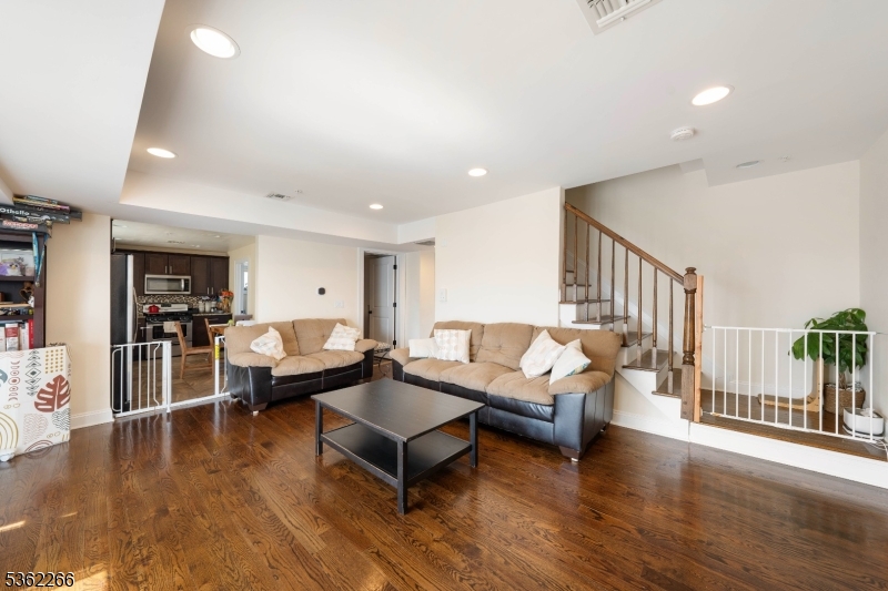Welcome to this bright and spacious multi-level condo, ideally located just three blocks from the train station and vibrant downtown Linden! This newer unit offers an unbeatable blend of comfort and convenience, perfect for commuters and anyone who loves being close to it all. Step inside to find a sun-drenched living room with large windows that fill the space with natural light. The main level features a roomy layout, including a powder room, an eat-in kitchen perfect for casual dining, and a dedicated laundry room for added convenience. Upstairs, you'll find two generously sized bedrooms and a full bath. The primary bedroom boasts a walk-in closet and lots of space, making it a comfortable retreat. Additional features include central air conditioning and heating, one assigned parking space, and a dedicated storage area on the ground level ideal for bikes, seasonal items, or extra belongings. Don't miss this move-in ready gem in a highly desirable location   schedule your showing today!