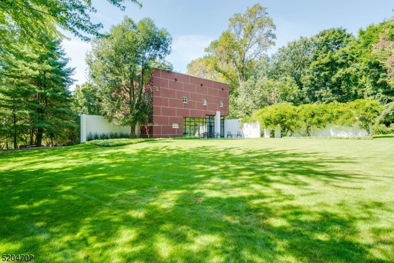 This magnificent house by UKZ Architects introduced Modernism to North Caldwell,19 miles from New York City. This one of a kind, award winning residence is a work of art. The home is comprised of two primary elements- two right angle L-shaped walls that intersect and provide context for the juxtaposition of inside and out. Nature is brought in with the L-shaped wall, beginning in the garden, adorned with a wisteria vine. Newly renovated Kitchen has Wolf Stove/Oven/ Microwave, Miele dishwasher, Subzero Refrigerator. Beautiful Master Suite with new Bath. Convenient to shopping, restaurants, museums, libraries, theatres, Montclair, train, bus to NY. Experience living in modern art!