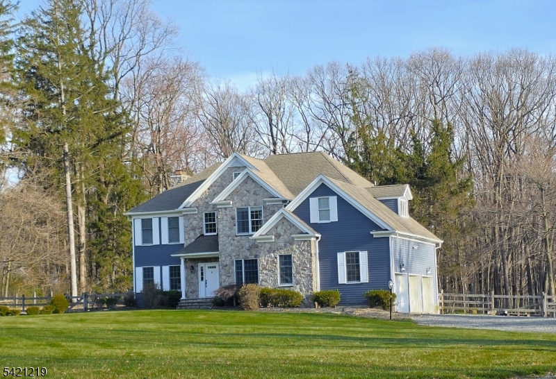 Spectacular custom Colonial with spacious open floor plan and 4+ lush usable acres in highly desirable Tewksbury Township.  Serene country setting just minutes to Rt 78!  Stylish features begin with the grand foyer entry, dual staircases, floor to ceiling stone fireplace, classic Cherry cabinets w granite countertops, convection wall ovens, large center island and tumbled marble floor as well as wood floors are just the beginning of an amazing list.  Engaging full beauty of the outdoors, is a framed back wall with an array of towering windows and French doors leading to expansive deck.  Upper level includes 4 bedrooms and a private office, as well as a spa inspired primary bath.  Extra block course for more ceiling height in full basement & middle beam free 3 car garage. This home is for sale and for rent.