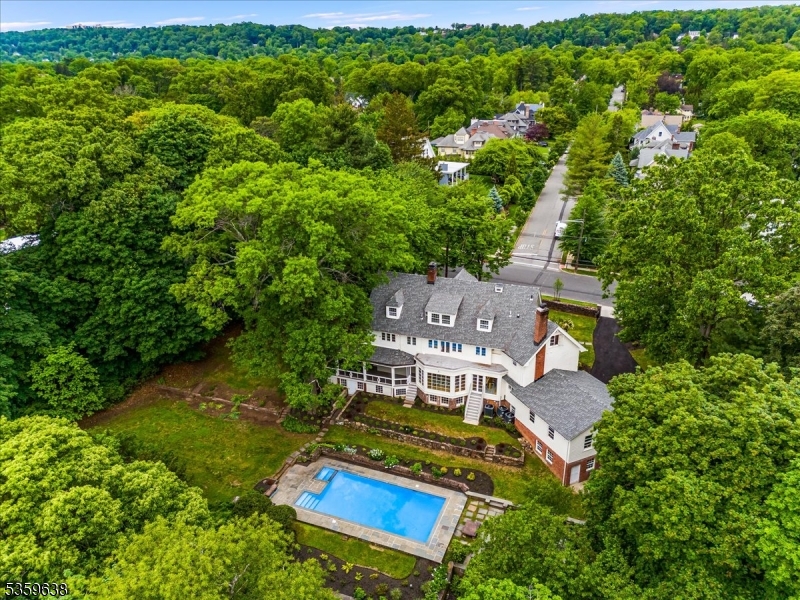 Beautifully reimagined through an exceptional renovation, this stately residence has been transformed into a luxurious home on an exquisite 1+ acre private lot. Curated with designer finishes by Adriana Smyth Interiors with an all new layout. Showcasing 6 spacious bedrooms and 4.2 elegantly appointed new baths, this residence offers luxurious living space designed for comfort and entertaining. A landmark of historical significance, the Tinkham-Volcker Estate was once the residence of Paul Volcker, esteemed Federal Reserve Chairman.This home has been fully updated from inside out, including new framing & subfloors, new electrical, new plumbing systems, new 3 zone HVAC, brand new roof, paved driveway & a new French drain with lifetime warranty. The newly designed custom kitchen features quartz countertops and top of the line appliances, including designer la Cornue gas range. The kitchen flows seamlessly to the elegant dining room with views of the private backyard. The first floor includes a custom newly built mudroom, attached 2 car garage (plus bonus detached garage), spacious office/den, inviting family room, & charming screened-in porch. Upstairs, the primary suite offers a sitting area, WIC, & spa-like, en-suite bath.The finished basement offers a greenhouse, rec room, and space for a guest suite. Brand new hardwood floors and stairs.The beautifully landscaped grounds feature a heated newly refinished Gunite pool with new pool cover, new Hayward pump and a tranquil oasis.