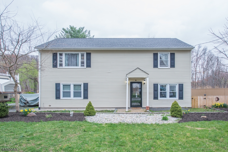 Totally move-in-ready raised ranch! Bright, open living space with oversized picture window & slider to beautiful back deck & yard. Located in lovely neighborhood, quiet dead-end street walking distance to NYC-Direct train. This is a home that offers many wonderful features & potential for more. Larger bdrms w/tons of storage. 1st Floor offers open layout- Living, Dining & Kitchen w/center island plus 2 bdrms & full bath. Spacious ground level provides den, office/bdrm, laundry, full bath & walk-out to fenced in backyard. In-law suite/mother-daughter potential. Newer Roof +Gas Furnace. HW Flooring. Mature trees, lawn & koy pond? very relaxing!! Extremely private backyard. Hard to find Desirable Denville Home! Great schools, vibrant DWTN- Denville & Mt. Tabor, shopping, nearby mass transit & major hwys.