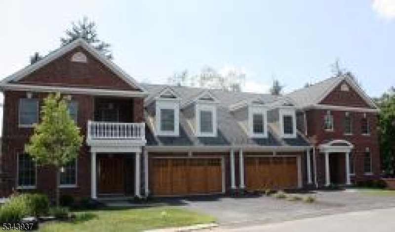 Stunning End Unit Townhome in Desirable Wheatsheaf Community....Minutes from Downtown Morristown & NYC Train!  Perfectly located just minutes from downtown Morristown and the direct train to NYC ideal for commuters and those who love the energy of town life with the tranquility of home. Step inside to soaring cathedral ceilings, oversized windows, and an open floor plan drenched in natural light, all overlooking private wooded views. Large deck runs the span of the back of the home. Main level features a spacious primary suite with access to back deck, a large walk-in closet and a private en suite bath, offering true one-floor living convenience. The second level features three additional bedrooms, including a Jack & Jill bath shared by two bedrooms and a private full bath for the third perfect for additional privacy. Enjoy the ease of a main-floor laundry room and direct access to the oversized 2-car attached garage. Finished lower level is a dream! It includes a fifth bedroom with walk-in closet and private fourth full bath, a recreation room, kitchenette, eat-in area, and walk-out access to a lovely backyard patio perfect for relaxing or entertaining.  This home combines space, luxury, and a truly unbeatable location. Whether you're commuting, entertaining, or just relaxing, this is one you do not want to miss!  Luxury, Location & Lifestyle All in One!