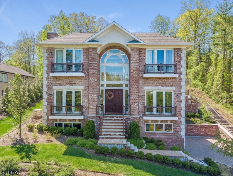 Be prepared to fall in love with this Custom built All Brick 5 bedroom 4 1/2 bath Center Hall Colonial with Panoramic View & 10' high ceilings, filled with great natural light as it faces south, & a gorgeous pool with large patio & terraced backyard! The home features a heated paver driveway, attached 3-car garage & elevator to all 3 levels. The home has an ideal open layout with a large gourmet eat-in kitchen with top of the line stainless steel Wolf and SubZero appliances, designer cabinetry with under cabinet lights, center island, totally open to family room with French doors to the stunning property and pool. The grand entrance hall opens to the dining room with a large butlers pantry with wine fridge and Fischer Paykel dishwasher drawer & to the living room with gas fireplace with Italian marble surround. There is a 1st level office off of the kitchen. The luxurious Primary Suite features a huge walk-in closet, sitting room with tray ceiling & easy access to patio & property & a spa-like bath with Victoria and Albert soaking tub & resort style shower. 3 more bedrooms, 1 en suite & 2 that share a bath, complete the 2nd level. Lower Level with en suite bedroom & bath, perfect as an in-law suite & laundry room. The pool & patio in the backyard are fit for a luxury hotel. Your private oasis! This stunning property is ideally located on a prestigious street in the highly rated Deerfield Elementary School District, just a 0.7 mile walk to Deerfield Elementary School!