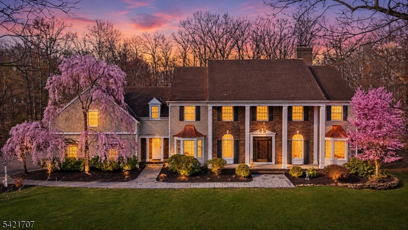 Set on a beautifully manicured property in one of Bridgewater's most sought-after enclaves, this distinguished estate embodies timeless sophistication and refined living. A stately facade framed by mature trees and seasonal blooms creates an unforgettable first impression, blending classic architecture with serene natural surroundings. Inside, graciously scaled interiors are designed for both elegant entertaining and everyday comfort. The home features five spacious bedrooms, including a private guest suite ideal for extended stays or in law suite. Two fireplaces anchor the living spaces with warmth and ambiance, offering inviting settings for intimate gatherings. The fully finished lower level adds 1,300 square feet of living with two separate entrances presenting exceptional flexibility, perfect for a private retreat, recreation space, or potential guest quarters. A 3-car garage complements the home with both convenience and ample storage. Thoughtfully designed and impeccably maintained, this residence offers a rare opportunity to own a sophisticated estate that seamlessly balances luxury, privacy, and functionality all within close proximity to Bridgewater's premier amenities, commuting routes, and top-rated schools.