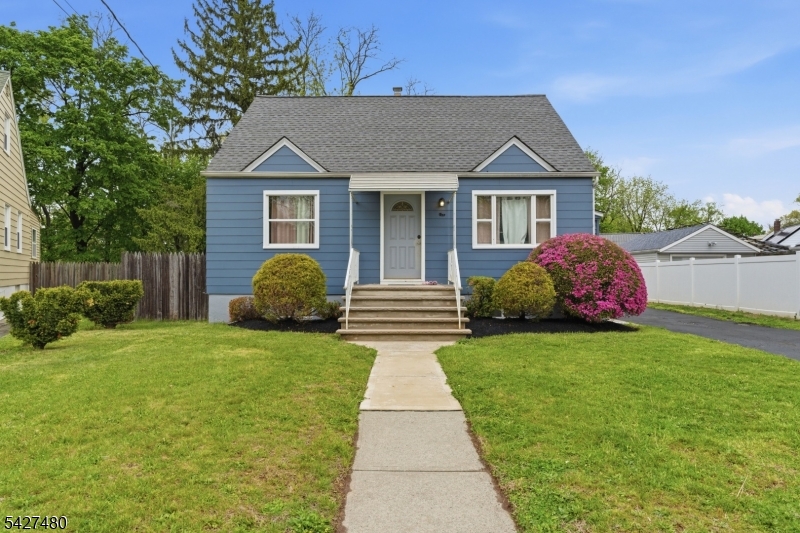 Welcome to this expanded Cape Cod-style home offering exceptional flexibility, space, and outdoor living on a quiet cul-de-sac. Designed with multi-generational living in mind, this unique property features great curb appeal, multiple entrances, resurfaced hardwood floors, crown molding, a bright living room with front porch access, two main-level bedrooms, and a renovated full bath. The kitchen offers tile floors, wood cabinetry, tile backsplash, and a large picture window, opening to a cathedral-ceiling Florida room with slider and driveway access. Upstairs includes a spacious loft with laminate floors, eave storage, a large walk-in closet, and a private primary suite with vaulted ceilings, recessed lighting, built-ins, and generous closet space. The finished lower level has its own driveway entrance and features a second kitchen, living area, full bath, utility room, and additional heated/cooled finished rooms with closets, ideal for extended living, guests, recreation, or flexible use. Outside, enjoy a fenced backyard with deck, newer vinyl fencing, paver patio, garden boxes, walkways, stone fireplace, and rear lot space. The oversized detached drive-through two-car garage adds versatility, while the attached cabana house includes a kitchenette, full bath, closet, and recessed lighting, perfect for entertaining or hobbies. Updates include a new roof, new rear sliders, replacement windows, updated electric panels, and approximately 5-year-old HVAC and hot water heater.
