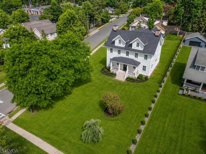 Unique chance to own quality new construction and experience in town living in this custom built home situated in the heart of Mendham Boro. This home features approximately  5,300 sq ft of finished living space blending classic inspiration with contemporary luxury. The open-concept main level offers 9-foot ceilings, 3-piece crown molding, and oak flooring. The gourmet kitchen includes custom white shaker cabinetry, a contrasting center island, quartz countertops with a full-height backsplash, professional-grade stainless steel appliances, a 36-inch 6-burner range, and a beverage center.The expansive family room features a floor-to-ceiling cultured stone fireplace. The primary suite offers a raised tray ceiling, custom millwork, and a spa-like bath with marble-inspired porcelain tile, an oversized shower, and a double vanity. The versatile floor plan includes a dedicated home office/living room, formal dining room, practical mudroom, a large second-floor bonus room, and a third-floor 3-room suite with a full bath. Additional features include multi-zone high-efficiency HVAC, LED recessed lighting, a front porch with maintenance-free decking, a side yard paver patio, and a finished lower level with high ceilings and a full bath. Local quality builder with attention paid to every detail. Enjoy proximity to Main Street Mendham.