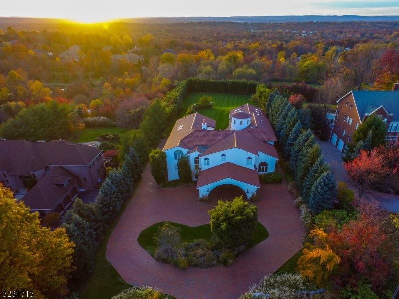 Resting on 1.5 acres of gorgeous property awaits this expansive Mediterranean estate! Designed for comfort and warmth, this custom home sends you on a permanent vacation. From the terracotta roof tiles to the soft and welcoming stucco entry, you are sure to experience a whimsical grandeur. The property's expansive layout and open floor plan maximizes the art of gracious living. Inside, the grand foyer opens to a two-story great room, the arched windows and sliding glass provides an effortless transition to outdoor living, and the many spacious bedrooms allow for an ample amount of interchangeable space. With a life sized chess board, indoor half Olympic swimming pool, professional racquetball court, and movie theater, there is no shortage of options for intellectual, artistic, and athletic pursuits. Come and find your true serenity!
