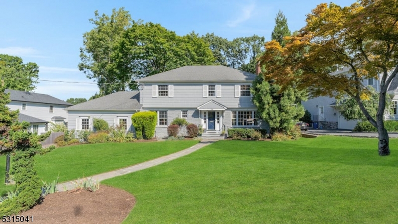 Beautiful Center Hall Colonial in Prestigious Poet Section of Short Hills. Nestled on a quiet, tree-lined street, this center hall colonial offers over 2,500 square feet of living space, plus a finished basement, on a private, park-like property. One block to the highly regarded Hartshorn School and close to the NYC Midtown Direct train.The first floor features a spacious living room with a wood-burning fireplace, a sun-filled eat-in kitchen, a formal dining room, a bright Florida sunroom, and a cozy library. Upstairs, the second floor has a master suite, along with three additional bedrooms. The finished basement offers a full bath, laundry room, and a flexible space ideal for an office or extra bedroom. Outside, enjoy a large backyard deck, perennial gardens, mature trees, and a charming tea garden, creating the perfect setting for both indoor and outdoor entertaining. The property also includes a spacious garage with extra parking, as well as a wet/dry sauna and spa hot tub for ultimate relaxation.This home combines elegance, comfort, and convenience, offering the best of suburban living just minutes from the city.