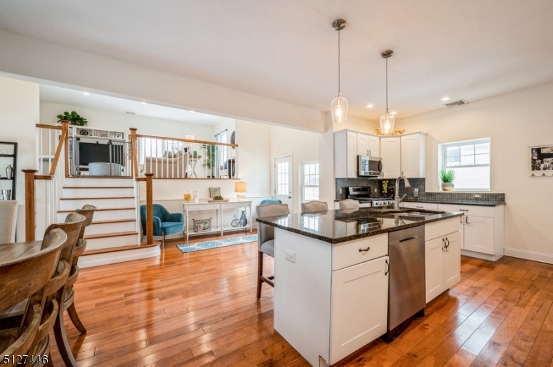 Spacious and stunning in a picturesque neighborhood! Custom updated Colonial split with 4 bedrooms, 2 full bathrooms, 1 half bathroom and an attached 1-car garage is situated on a tree-lined street close to everything. This recently renovated home is less than a mile to schools and near stores and restaurants, Morris Plains train station, major highways and several area parks. You'll find light-filled living and entertaining spaces that flow outside to a beautiful deck overlooking the deep, level back yard. The many recent updates include a new kitchen, bathrooms, floors and carpeting, central air conditioning, heating, electric, water heater, windows, roof, deck, and exclusive driveway. The entry foyer opens to a bright living room with a charming, refinished sliding barn door leading to a sunny office and a powder room. The open concept dining area flows to the crisp white kitchen with granite counters, chic tile backsplash, stainless steel appliances and a center island with seating. A few steps up is the light and airy family room with sliding glass doors to the deck. The upper levels include three bedrooms, a full updated hallway bathroom, a convenient upstairs laundry room and the spacious primary bedroom suite complete with a walk-in closet and private updated bathroom. A finished basement and attached garage complete the package of this impeccable, move-in ready home.