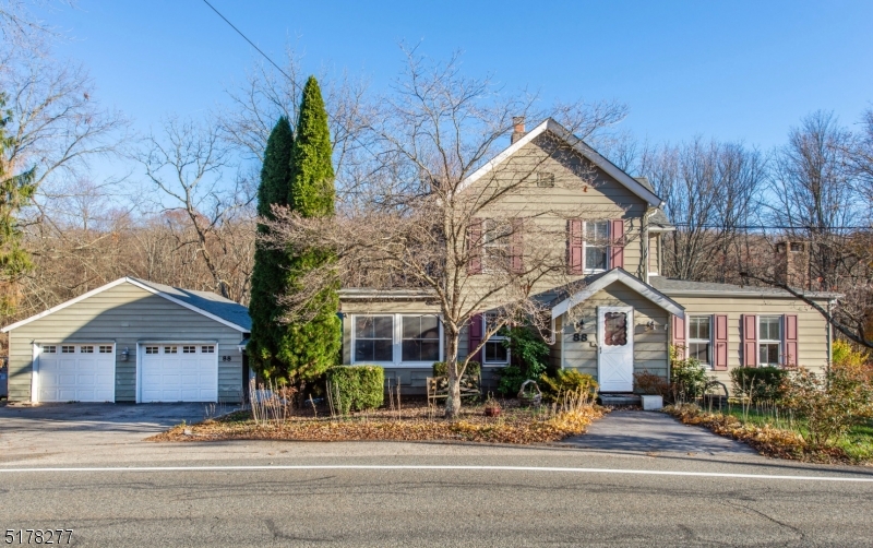 Versatility! Older colonial, modernized with charm and character.  Hardwood flooring, oak eat-in kitchen with adjacent office and space for a huge pantry, formal dining, den with pellet stove, formal living room with wood burning fireplace, full bath and sliders to deck overlooking private backyard. Ground level features large laundry room with access to backyard, huge family room with vaulted ceiling and adjacent bedroom/office and garage access. Second floor features 3 spacious bedrooms and full renovated bath. Pretty wooded private property with pond, lots of parking. Propane used for hwh, stove and dryer. Property size includes .11 acres in Andover Twp. Block 7 Lot 3.01; Lot sizer per survey is 2.09; Septic System 2016; Roof 2021; Furnace 2016; Water softener and hot water heater 2020.